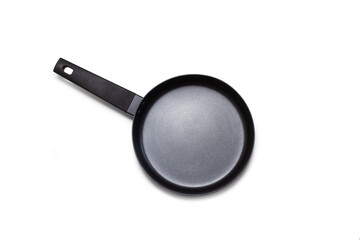 A black frying pan in a top view on a white background with copy space