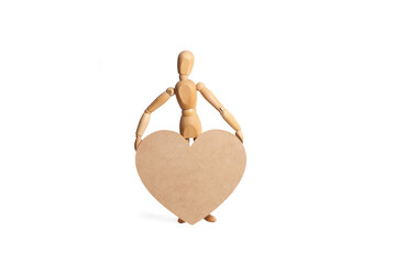 A wooden mannequin toy holding a big wooden heart on a white background with copy space