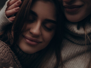Close-up serene lesbian couple with tender hug, support and comfort
