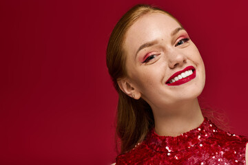 Bright red sequins enhance the joyful spirit of a young woman smiling with confidence
