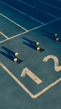 Vertical blue running track starting blocks long shadows new year goal.3d rendering