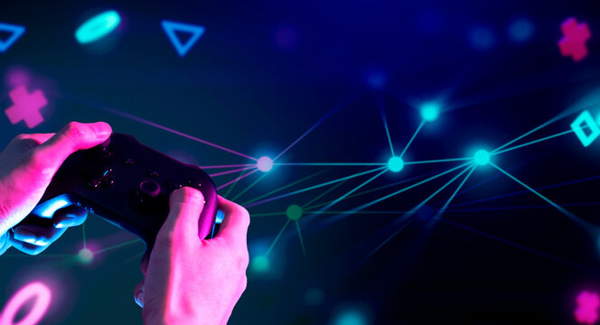 gamer hand touching and interactive to holographic of gaming joystick controller, game and esports technology