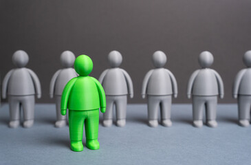 A green man among gray people. Talented. The best candidate for the job. Concept of leadership, creative hiring and HR analytics. Recruitment, innovation and team development.