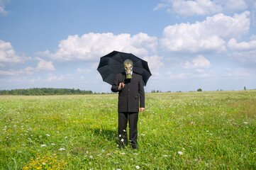 man in gas-mask on meadow.