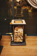 Wood storage and fire preparation setup in a cozy space