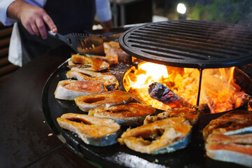 Grilling fresh fish over an open flame outdoors