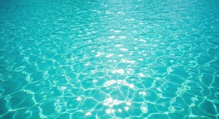 Obraz premium Sparkling turquoise water surface with sun-dappled reflections and ripples