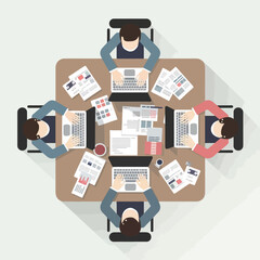 Top view of business people working on laptops and documents at office table creative team collaborating on project in modern workspace