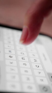 fast thumb action on device, closeup of fingers rapidly typing cyrillic characters on screen, focused image capturing quick thumb and finger movements in modern communication context