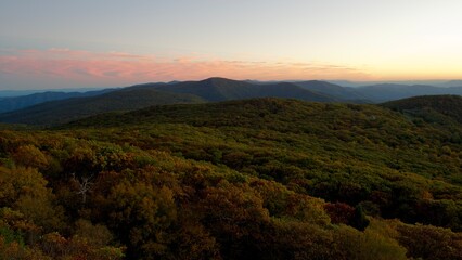 Naklejka premium Dusk settles over Shenandoah. The sun sets beyond the mountains in this expansive autumn view from Shenandoah National Park, Virginia. 