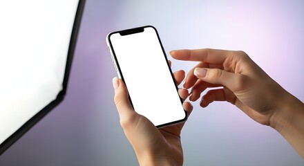 Persons hands holding a smartphone with a blank screen against a soft background.