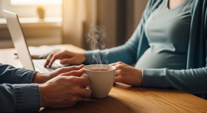 Pregnant woman and partner using a laptop, symbolizing support and remote work balance.