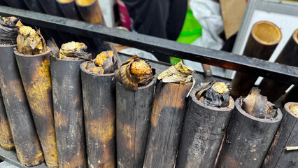 lemang bambu, made from glutinous rice wrapped in banana leaves and cooked inside charred bamboo...