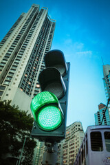 Urban traffic signal displaying a bright green light