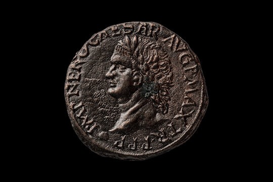 Roman Dupondius coin replica of the Roman Emperor Nero AD 37-68 portrait obverse cut out and isolated on a black background, ancient coinage collecting stock photo 