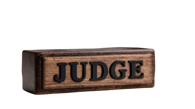 Closeup wooden judge nameplate with engraved bold lettering symbolizing law authority justice courtroom legal profession concept displayed clearly on white background