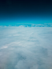 Low earth orbit above the horizon turquoise green space and white clouds