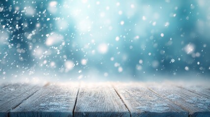 Winter landscape with softly falling snowflakes over empty wooden floor, blurred blue background with sparkling snow creating serene and frosty atmosphere