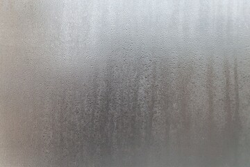 A close up of a glass window with water droplets on it