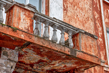 An old building with a balcony with a railing on it
