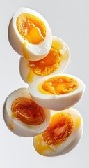 Soft-boiled eggs, halves in mid-air