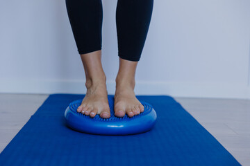 engaging core muscles through subtle microadjustments on inflatable cushion in peaceful exercise environment