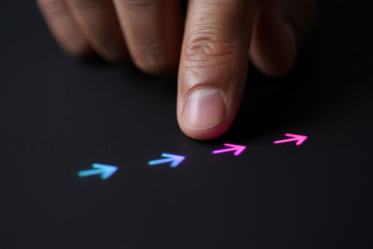 Finger Touching Illuminated Colorful Arrows on Black Background Concept of Directional Choices Technology and Guidance with Modern Aesthetic