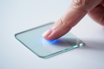 Finger Touching a Glass Plate with Glowing Blue Circle Modern Interactive Interface Concept Representing High Technology and Touchscreen