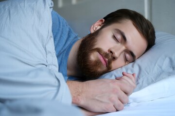 Man sleeping peacefully in bed restful sleep and relaxation concept image