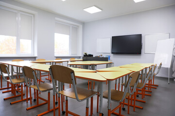 Classroom with yellow desks and chairs at school
