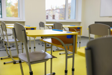 Stylish classroom with desks and chairs at school, closeup