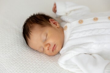 Peaceful Slumber Newborn Baby Sleeping Soundly in White Outfit on White Textured Bed