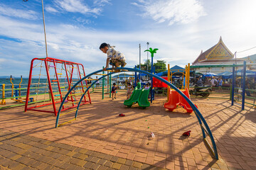 Little school boy enjoy climb outdoor playground city