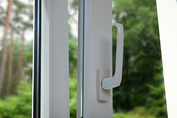 Window open for ventilation, closeup. Beautiful view through glass