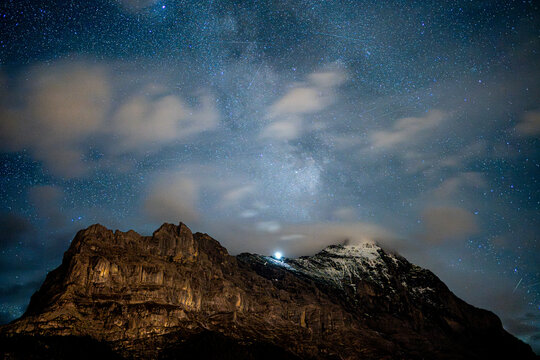 stars and clouds over the swiss mountains