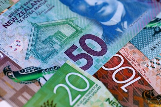 New Zealand dollar money bills in big amount on table close up. Rich life concept in New Zealand. Business and economy