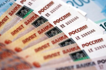Russian ruble money bills banknotes lies in big pile on table close up. Concept of finances and...