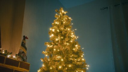 Gifts wrapped in ribbons under a Christmas tree at home
