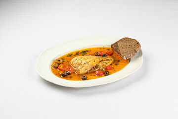 Warm fish fillet served in aromatic vegetable broth with olives and fresh herbs 