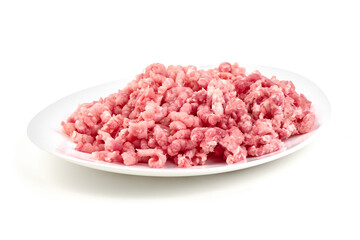 Freshly ground light pink pork, ready for cooking, sits piled high on a white plate, isolated on white background