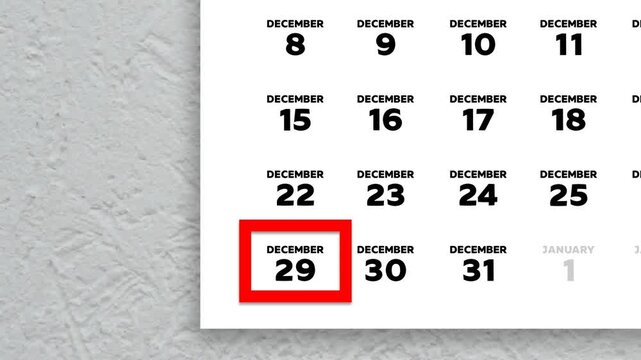 The date December 29th marked with a red cursor on the wall calendar 2025
