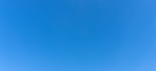 Low angle view and full frame of beautiful light blue sky without clouds in the afternoon on sunny day used as natural background texture in decorative art work