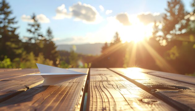 Paper Airplane Ready for Takeoff Golden Sunlight on a Wooden Table - Powered by Adobe