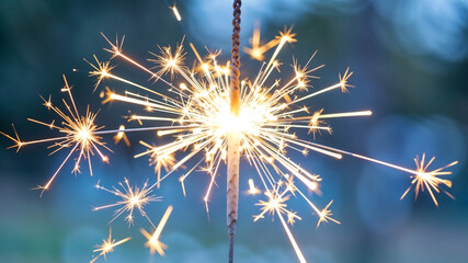 Close up sparkler with festive lights New year background