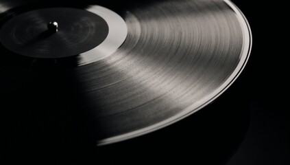 Striking vinyl record against dark background focusing on textured grooves and reflective surface for music lovers
