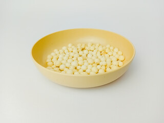 Pilus snack on a round plate, isolated on white background.