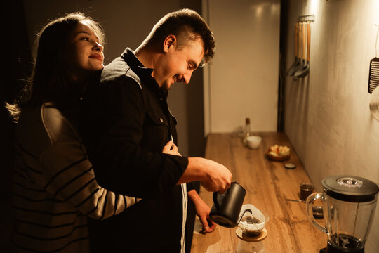 Relax. couple in love drinking coffee, talking and bonding in the kitchen. together chill