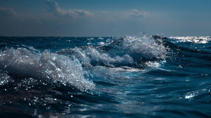 Expansive blue sea under clear sky with gentle waves reflecting sunlight and distant horizon in peaceful coastal landscape