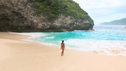 Rear View Nude Woman On Secluded Tropical Beach With Turquoise Surf