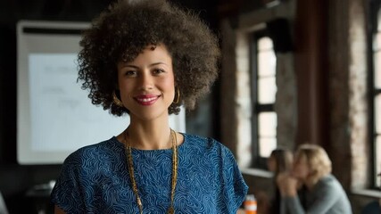 Smiling businesswoman with curly hair in a meeting, looking at the camera - Powered by Adobe